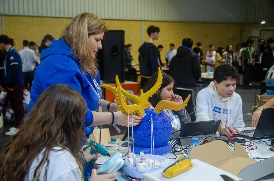 Robotics club students programming, building and competing